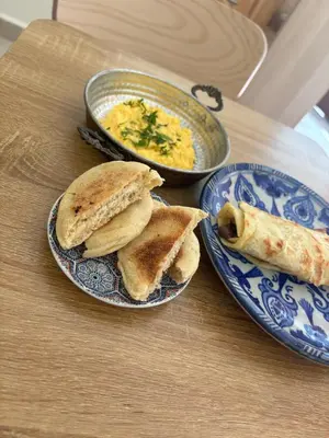 a table with two plates of sandwiches and a bowl of soup at Luxury apartments in Mansouria