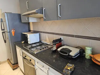 a kitchen with a stove and a toaster on a counter at Appartement au centre-ville, calme et lumineux in Casablanca