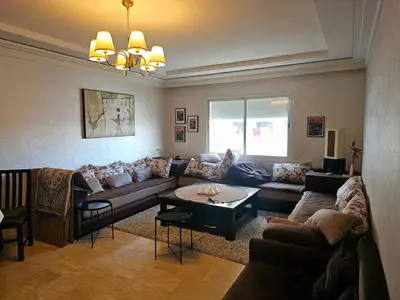 a living room with a couch and a table at Appartement au centre-ville, calme et lumineux in Casablanca