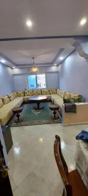 a living room with a couch and a table at Appartement idéal pour familles in Temara