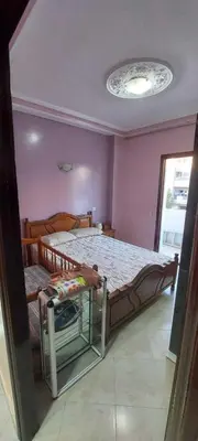a bedroom with a large bed in a purple room at Appartement idéal pour familles in Temara