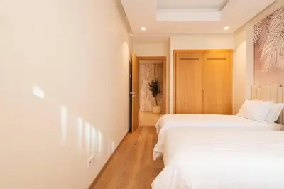 a bedroom with two beds and a door at Luxurious 2BR 2BA For Families and groups in Casablanca