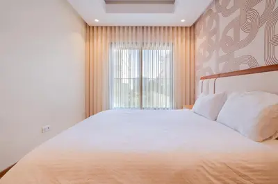 a bedroom with a large bed and a window at Luxurious 2BR 2BA For Families and groups in Casablanca