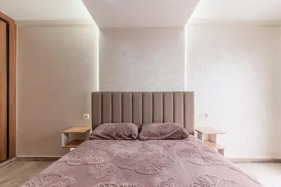 a bedroom with a large bed with a purple blanket at Contemporary Hideaway Design and Tranquility in Casablanca