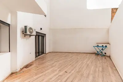an empty room with a fan and a wooden floor at Contemporary Hideaway Design and Tranquility in Casablanca