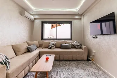 a living room with a couch and a table at Contemporary Hideaway Design and Tranquility in Casablanca