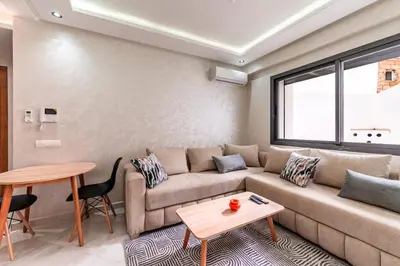 a living room with a couch and a table at Contemporary Hideaway Design and Tranquility in Casablanca