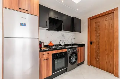 a kitchen with a white refrigerator and a stove at Contemporary Hideaway Design and Tranquility in Casablanca