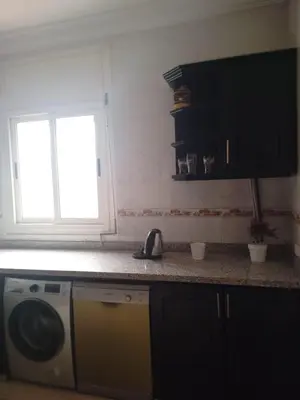 a kitchen with a washing machine on a counter at Joli appartement bien équipé-Casablanca in Casablanca