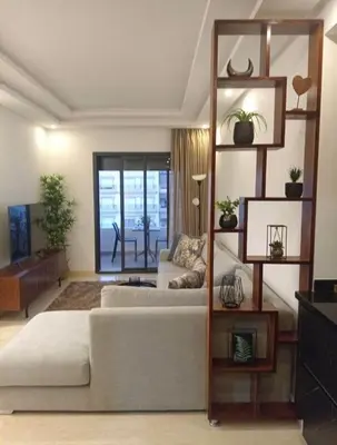 a large living room with a white couch and a large window at Prestige appartements in Casablanca