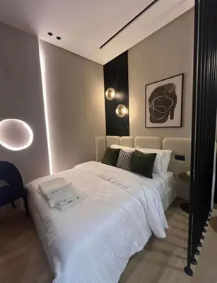 a bedroom with a large bed with white sheets at Prestigia apartments in Casablanca