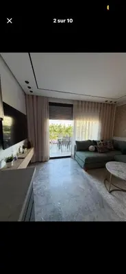 a living room with a couch and a table at Prestigia2 apartments in Casablanca