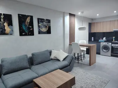 a living room with a couch and a table at Un studio luxueux au centre de Casablanca in Casablanca