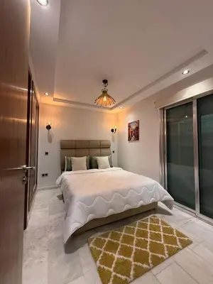 a bedroom with a large bed and a large window at Élégant studio moderne Anoual Maarif Casablanca parfaitement équipé in Casablanca