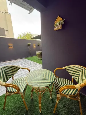 a patio with two chairs and a table at Élégant studio moderne Anoual Maarif Casablanca parfaitement équipé in Casablanca