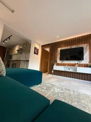 a living room with a couch and a flat screen tv at Élégant studio moderne Anoual Maarif Casablanca parfaitement équipé in Casablanca
