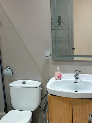 a bathroom with a white toilet and a sink at Très joli appartement très calme, très agréables pour un séjour en famille au haut Agdal Rabat in Rabat