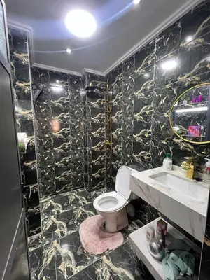 a bathroom with a toilet and a sink at Appartement near the airport in Deroua