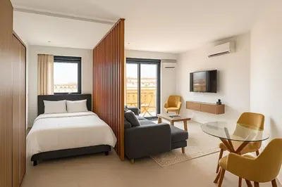 a bedroom with a bed and a couch and a table at superbe loft au cœur de la ville in Casablanca