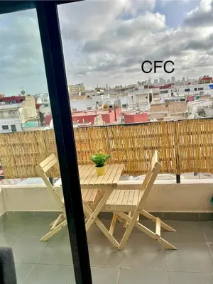 a table and chairs on a balcony with a view at superbe loft au cœur de la ville in Casablanca