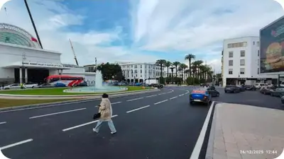 a woman crossing a street in a city at Hassan in Rabat