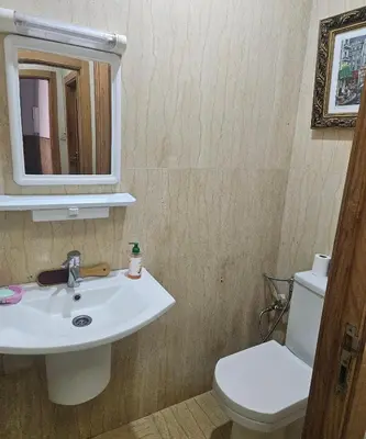 a bathroom with a sink and a toilet and a mirror at Hassan in Rabat
