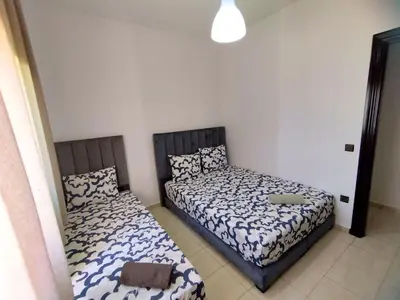 two beds in a small room with at lodgeocean in Rabat