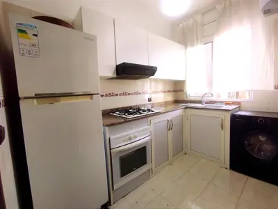 a kitchen with a white refrigerator and a stove at lodgeocean in Rabat