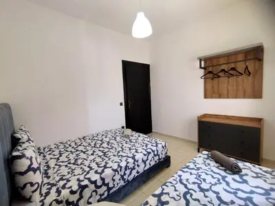 a bedroom with a bed and a dresser at lodgeocean in Rabat
