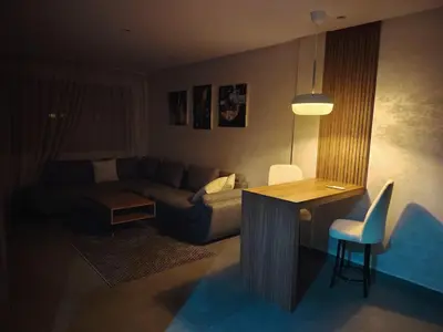 a living room with a couch and a table at Studio luxueux in Roches Noires