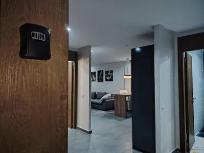 a hallway with a door and a living room at Studio luxueux in Roches Noires