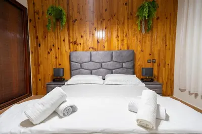 a bedroom with a large bed with towels on it at Bel appartement piscine & plage - Mohammedia in Mohammedia