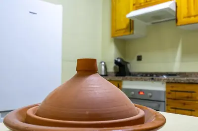a wooden object sitting on top of a kitchen counter at Bel appartement piscine & plage - Mohammedia in Mohammedia