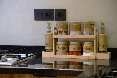 a spice rack in a kitchen next to a stove at Socrates Prestige, quartier Les Princesses in Casablanca