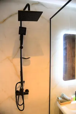 a shower in a bathroom with a glass wall at Socrates Prestige, quartier Les Princesses in Casablanca