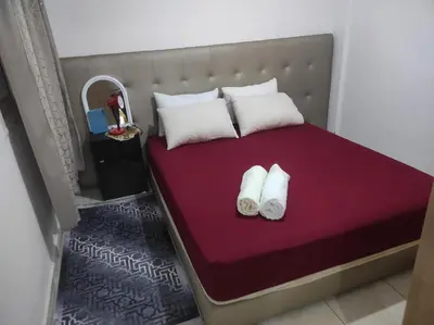 a bedroom with a bed with two towels on it at appartement familial a 5min de l'hôpital Mohamed 6 in Bouskoura