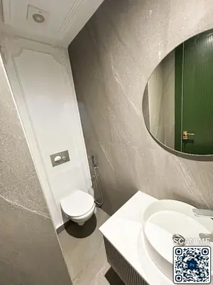 a bathroom with a toilet and a sink and a mirror at residence resowod in Maarif