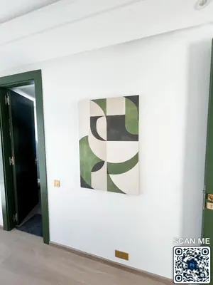 a painting on a wall in a room with a door at residence resowod in Maarif