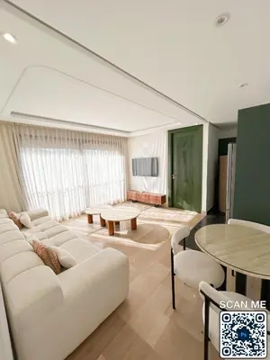 a living room with a white couch and a table at residence resowod in Maarif