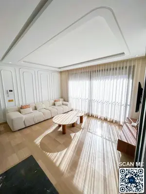 a living room with a couch and a table at residence resowod in Maarif