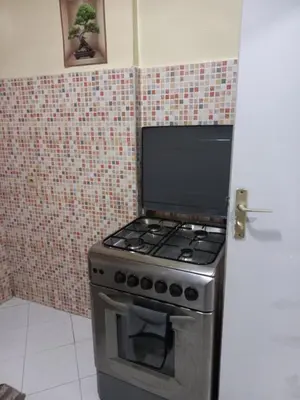 a stove top oven in a kitchen next to a door at IDY HOME's in Casablanca