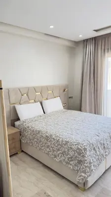 a bedroom with a large bed and a window at Centre Casablanca Studio karachi 24 in Casablanca