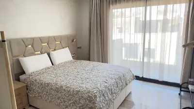 a bedroom with a bed and a large window at Centre Casablanca Studio karachi 24 in Casablanca