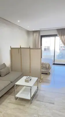 a living room with a couch and a table at Centre Casablanca Studio karachi 24 in Casablanca
