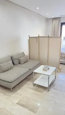 a living room with a couch and a table at Centre Casablanca Studio karachi 24 in Casablanca