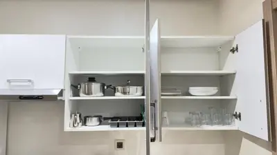 a kitchen with white cabinets with pots and pans at Centre Casablanca Studio karachi 24 in Casablanca