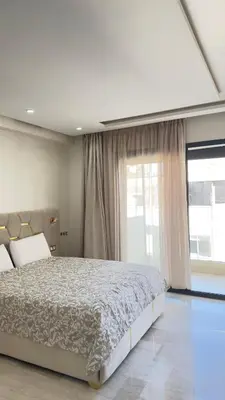 a bedroom with a large bed and a large window at Centre Casablanca Studio karachi 24 in Casablanca