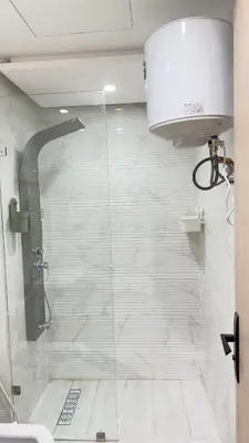 a shower with a glass door in a bathroom at Centre Casablanca Studio karachi 24 in Casablanca