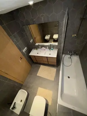 a bathroom with a tub and a toilet and a sink at Appartement 1 chambre à rabat imkan in Rabat