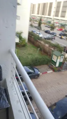 a view of a car on a balcony of a building at Hébergement en lit dans chambre et salle de bain partagées pour Hommes in Rabat